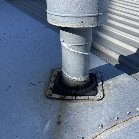 Job photo 5: a roof flue with the conduit run behind it